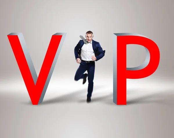 Young businessman in the middle of word 'vip' — 스톡 사진