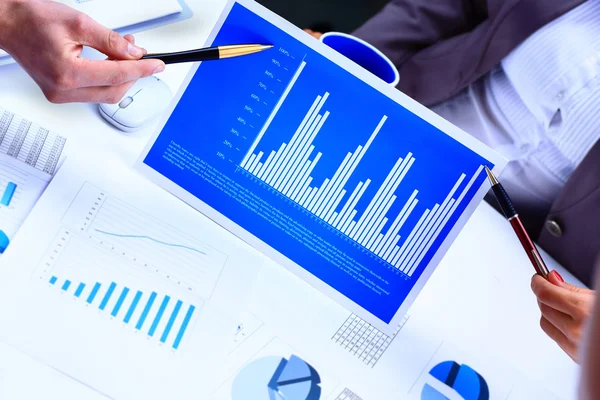 Financial paper charts and graphs on the table Stock Photo