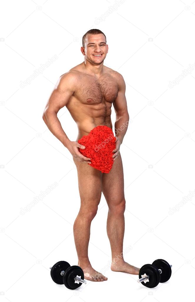 Photo of naked athlete man with strong body, with big red heart in his arms