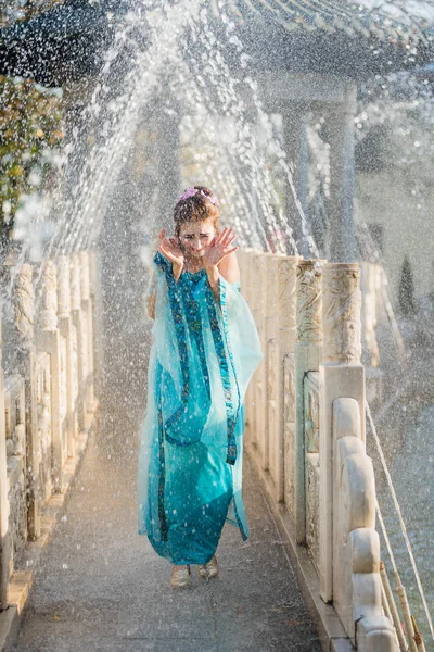 Pretty young geisha in water drops in blue dress — Stock Photo, Image