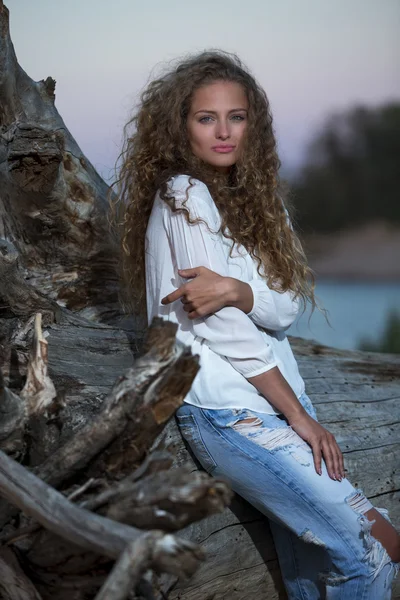 Beautiful young woman with long curly hair — Stock Photo, Image