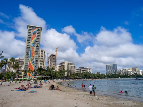 Sun lovers on Waikiki beach at the Hawaiian Hilton — Stock Photo, Image