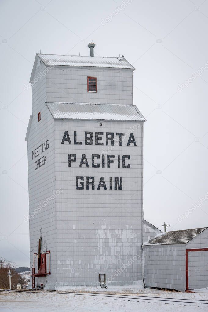 Meeting Creek, Alberta - April 11, 2021: Grain elevators in the small town of Meeting Creek.
