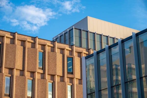 Mix of modern and older building styles at sunset.