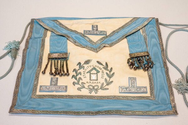 Decades old masonic apron on white background.