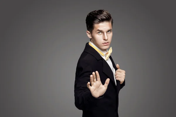 Portrait of young trendy groom with yellow bow-tie on gray backg — Stock Photo, Image