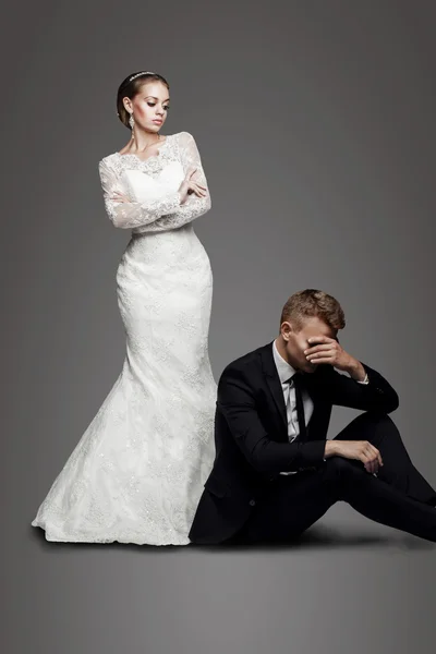 Beautiful bride looking on sad groom — Stock Photo, Image