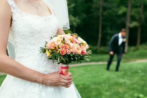 Невеста держит свадебные букеты и ждет жениха на свадьбе — стоковое фото
