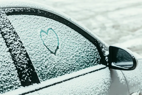 Serce na szyby samochodu pokryte puszystym śniegu — Zdjęcie stockowe