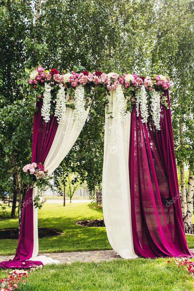 Lilac wedding arch with flowers on ceremony place Stock Photo by ...