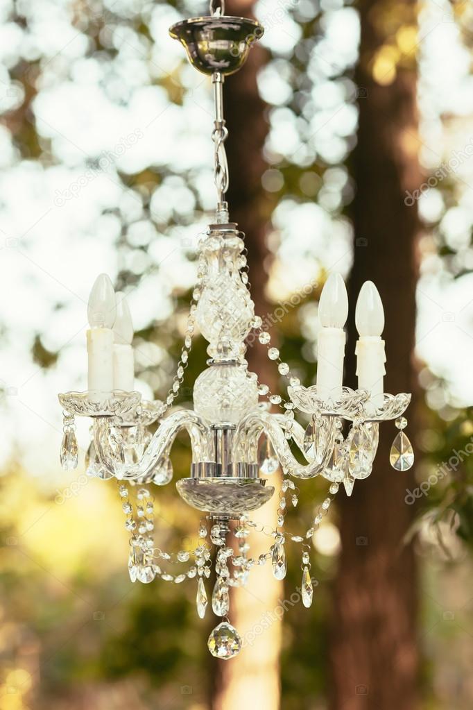 chandelier wedding decoration outdoor on ceremony  in forest