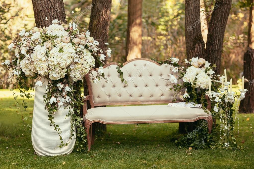 Luxury wedding decorations with bench, candle and flowers compis