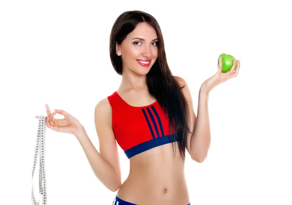 Jeune femme mince avec ruban à mesurer et pomme — Photo