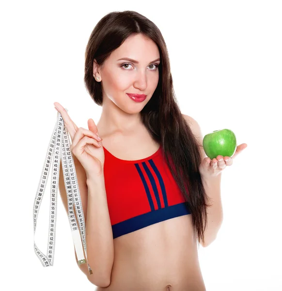 Jeune femme mince avec ruban à mesurer et pomme — Photo