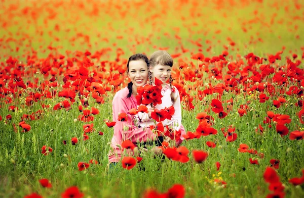 Happy mother with a child in a field — Stock Photo, Image
