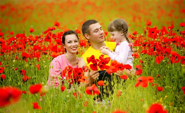 Happy family walking on the field — Stock Photo, Image