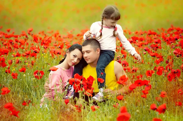 Happy family walking on the field — Stock Photo, Image