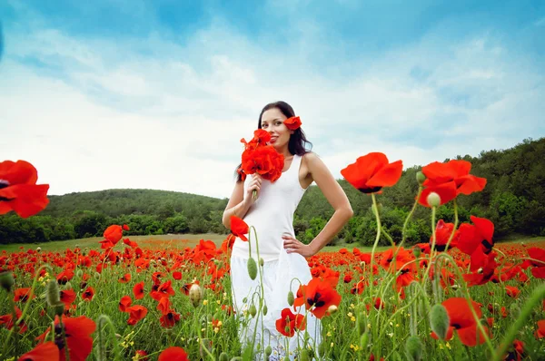 Porträt einer schönen Frau auf einem Feld mit Blumen — Stockfoto
