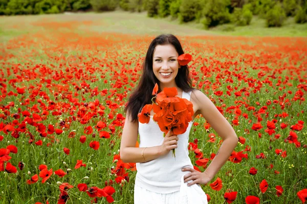 Portret pięknej kobiety w polu z kwiatami — Zdjęcie stockowe