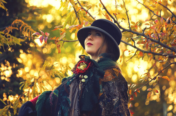 Portrait of a pretty girl in the autumn park