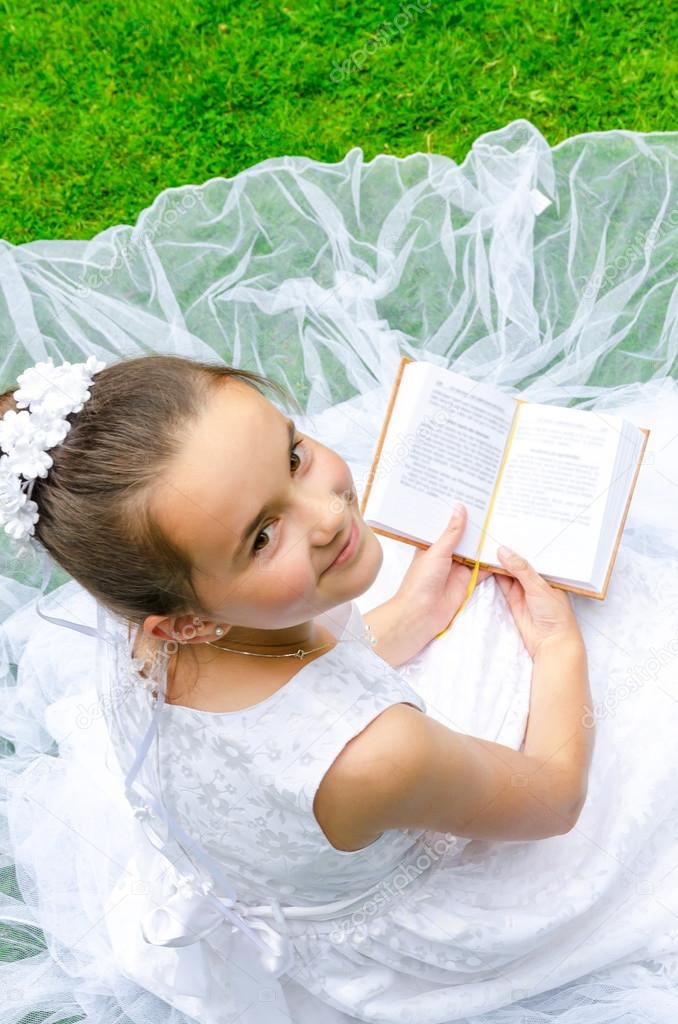 Girl reading First Holy Communion
