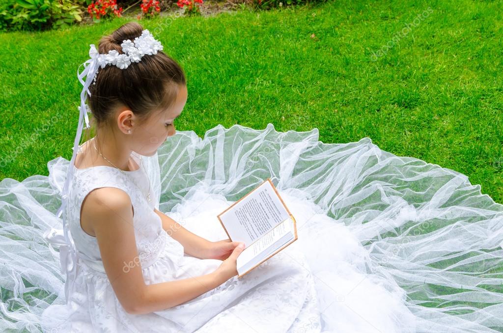 Girl reading First Holy Communion