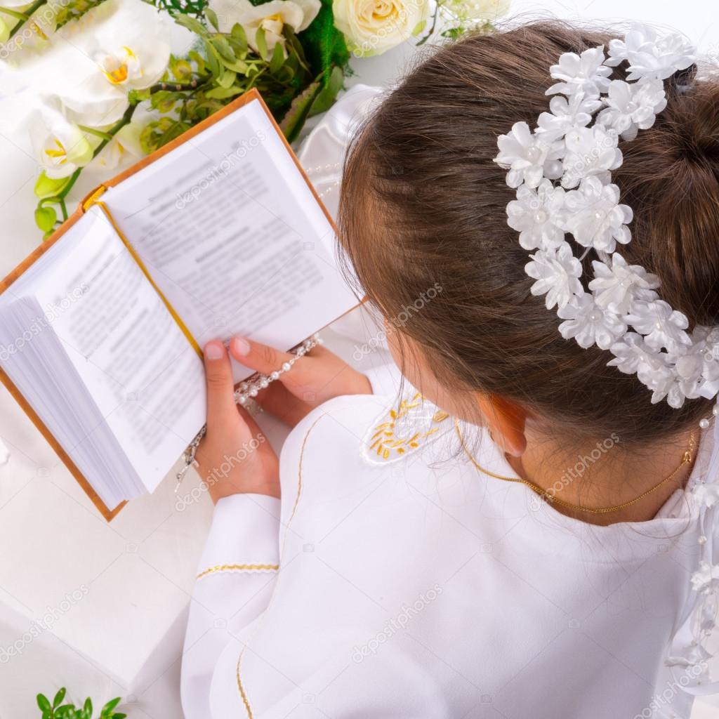 Girl reading First Holy Communion