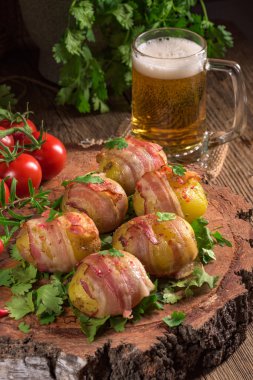 Baked potatoes wrapped in ham clipart