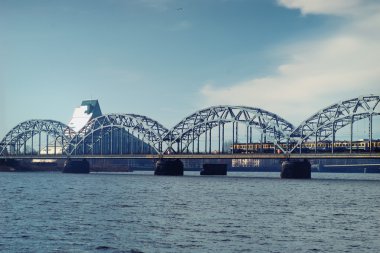 Demiryolu köprüsü üzerinde erken ilkbaharda Riga'da tren.