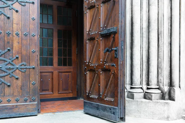 Old wooden door with metal forging — Stock Photo, Image