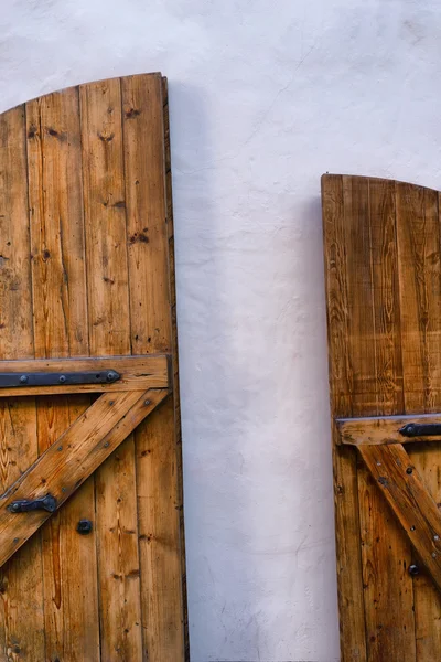 Yellow wooden door against a white wall — Stock Photo, Image