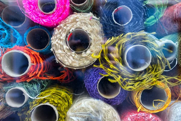 Colorful fabric rolls in a glass — Stock Photo, Image