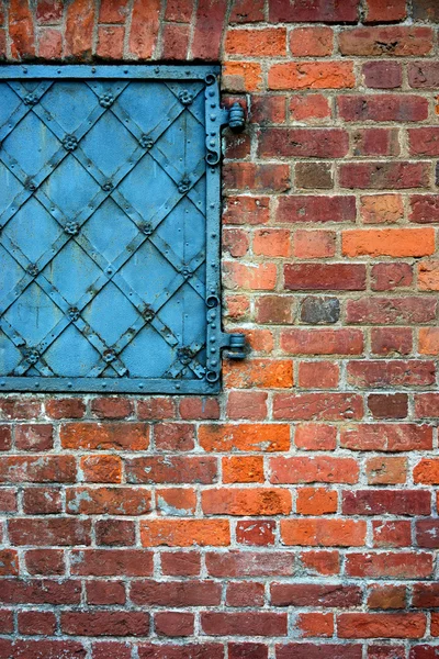 Brick wall with an old metal door — Stock Photo, Image