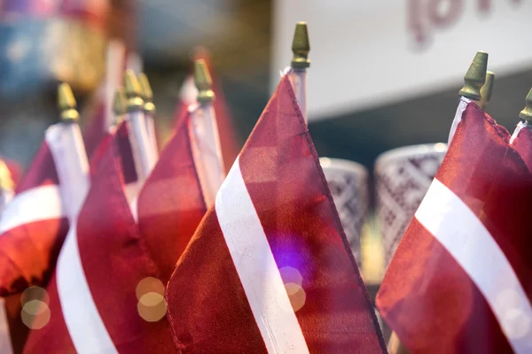 Latvian national flags in a shop window — Stock Photo, Image