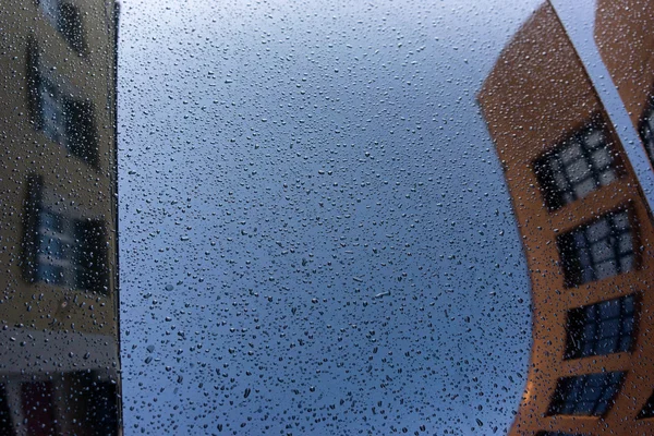 Reflection of the city in a car with raindrops — Stock Photo, Image
