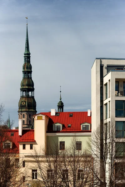 Spire of the cathedral with a cock on a background of the old to — Stock Photo, Image