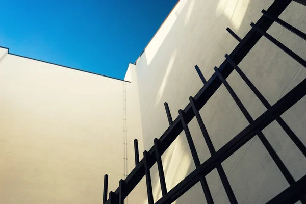 Detail of facade of the house and the iron gates — Stock Photo, Image