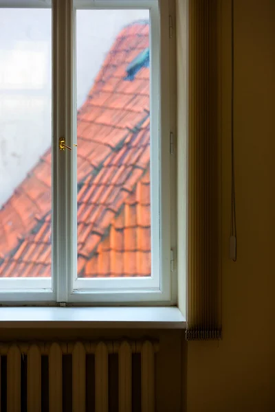 Tiled roofs of the window blinds lines and heating radiators — Stock Photo, Image