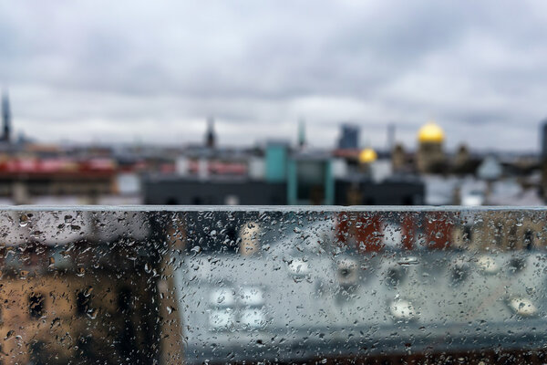Roofs and spiers of the city behind a glass partition in the rai