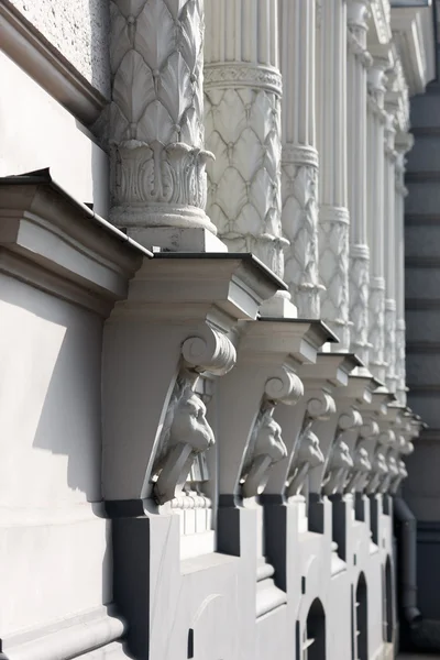 Colonnade en un edificio con la cabeza de la decoración león — Foto de Stock