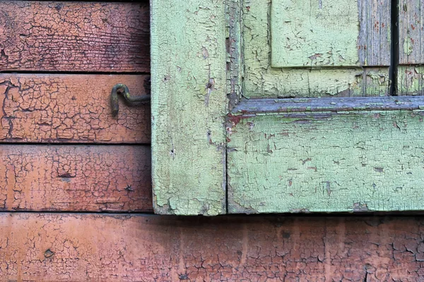 Fragment of wooden shutters on an old house wall — Stock Photo, Image