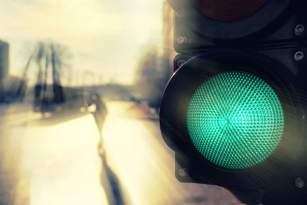 Pedestrian street in the sun at a traffic light in the spring — Stock Photo, Image