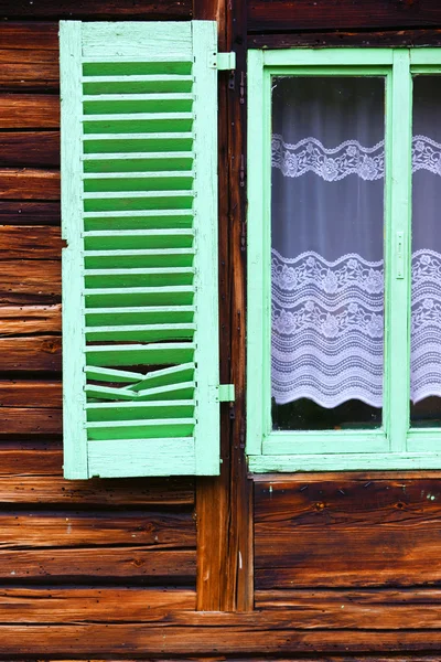 Green wooden window shutters on old house — Stock Photo, Image