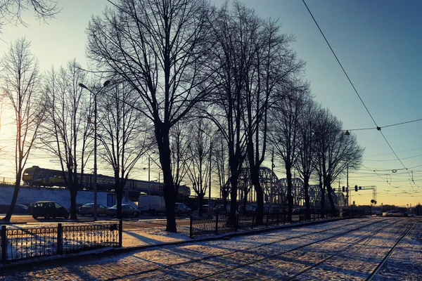 Движение автомобилей по улице в городе рядом с поездом — стоковое фото