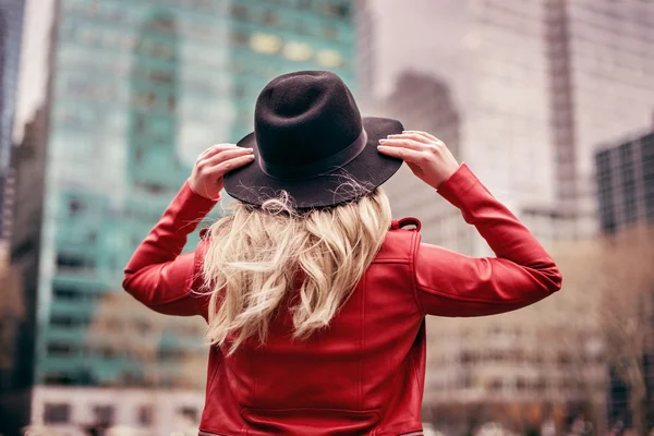 Uma jovem mulher usando um chapéu está andando nas ruas de Nova York — Fotografia de Stock