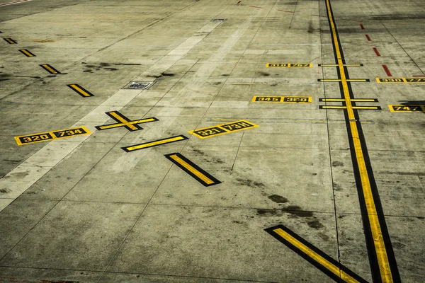 Schwarz-gelbe Flughafenmarkierungen auf Beton — Stockfoto