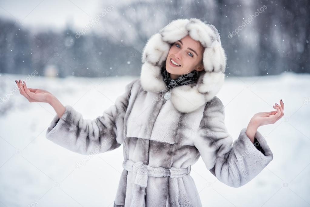 Woman have fun on the snow in winter forest