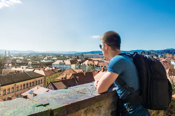 Tourist man looking to a beautiful view of the city Ljubljana — Stock Photo, Image