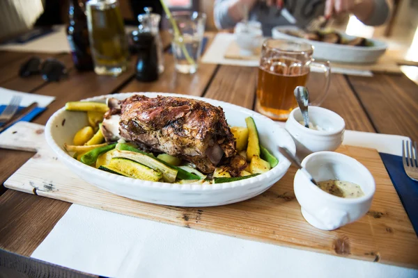 Traditional czech dinner with roasted pork leg and beer at the restaurant — Stock Photo, Image