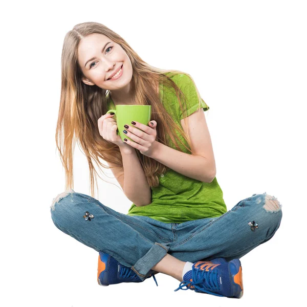 Happy woman sitting with coffee mug isolated on white — Stock Photo, Image